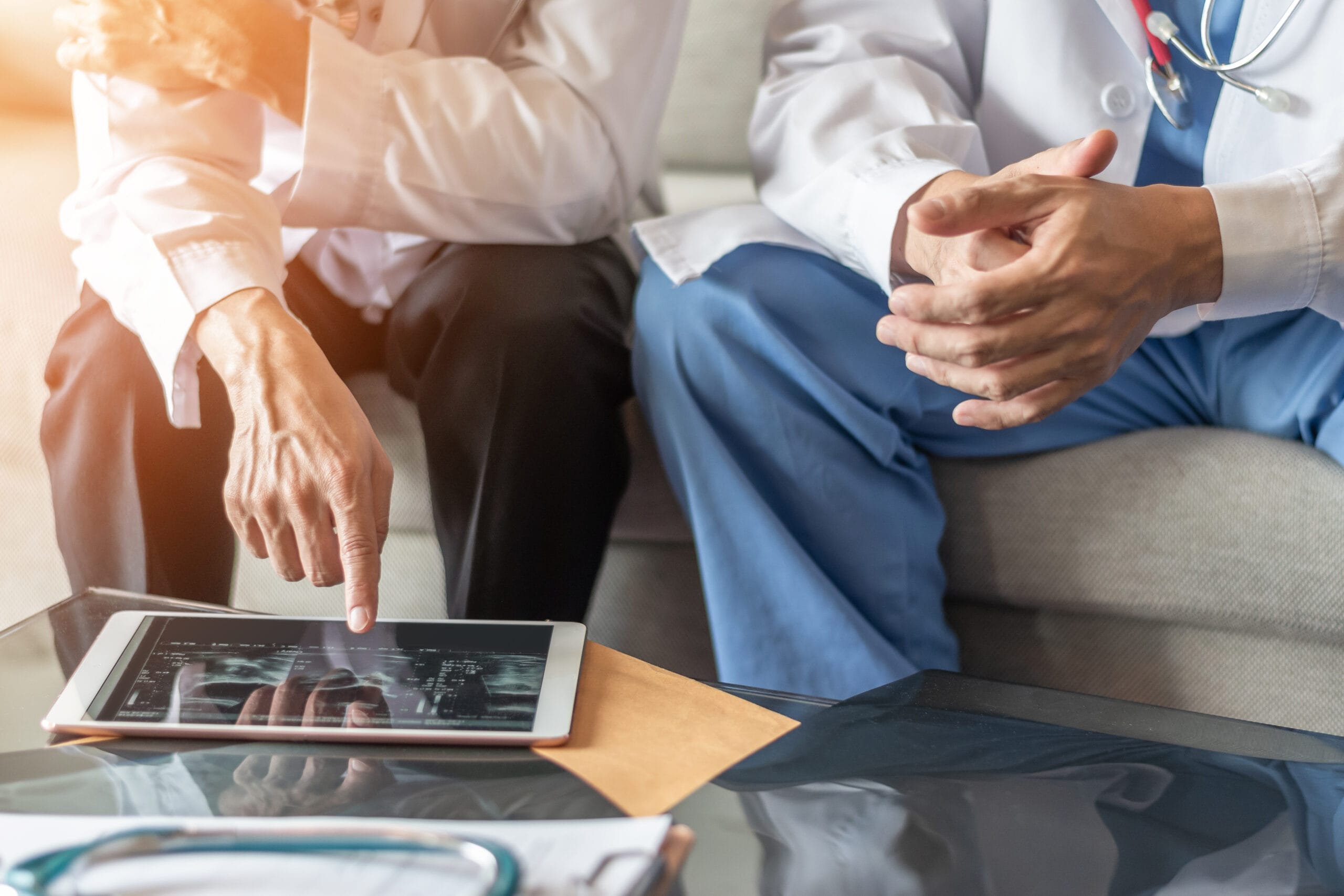 Image of medical team going over an image on an ipad